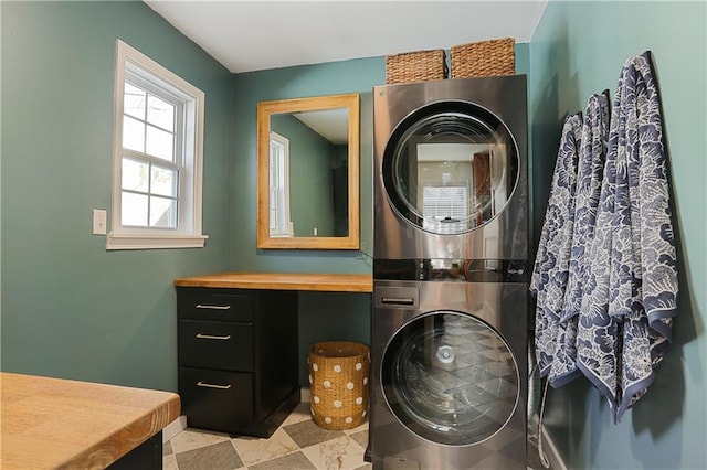 bathroom with stacked washer / drying machine and vanity