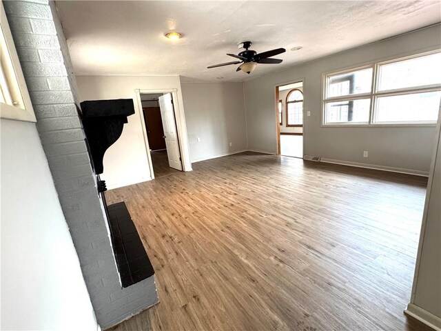 interior space with ceiling fan and wood-type flooring