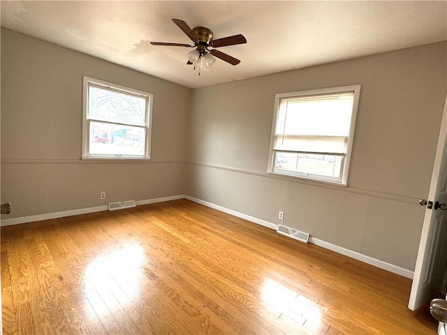 empty room featuring ceiling fan and light wood-type flooring