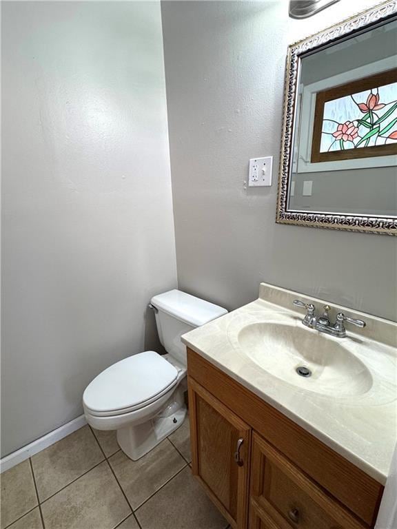 bathroom featuring vanity, tile patterned floors, and toilet