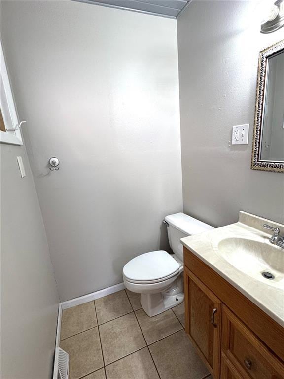 bathroom with vanity, tile patterned floors, and toilet