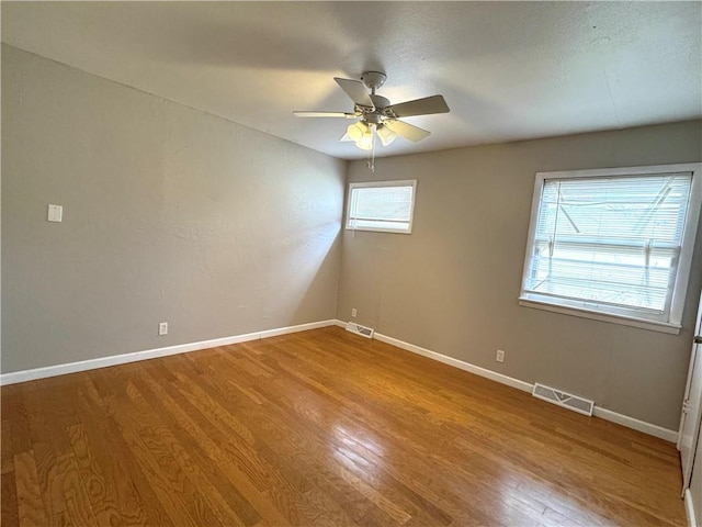 unfurnished room with wood-type flooring and ceiling fan