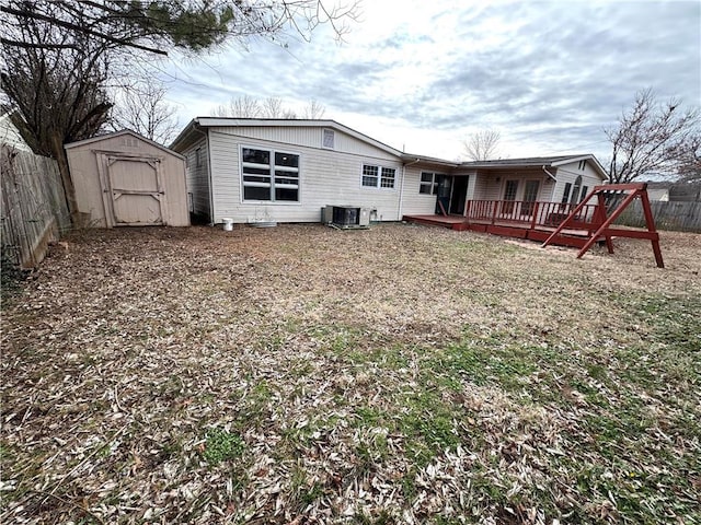 rear view of house with a wooden deck, a storage shed, and central air condition unit