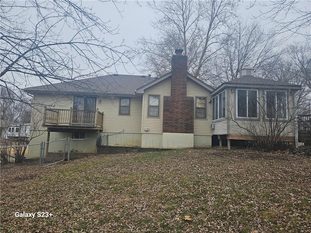 rear view of property with a sunroom