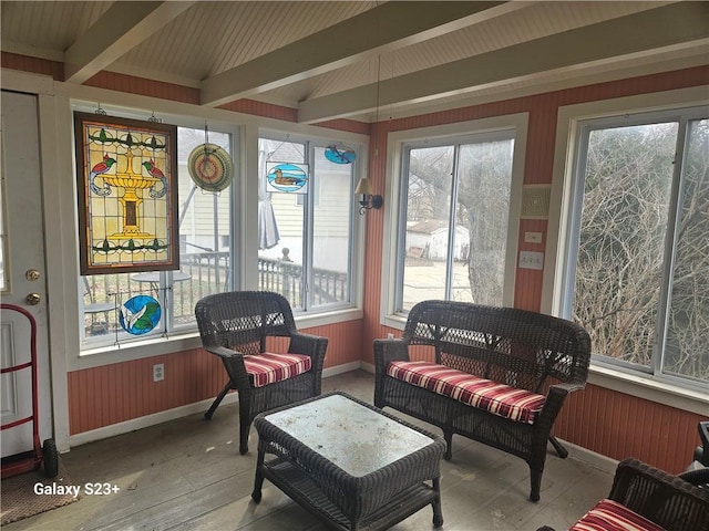 sunroom / solarium with lofted ceiling with beams and a healthy amount of sunlight