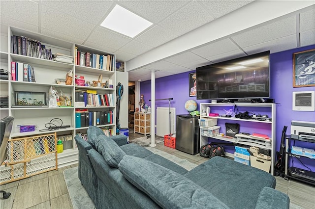 living area with a drop ceiling