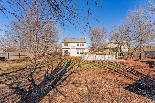 view of yard featuring a fenced in pool, a fenced backyard, and a wooden deck