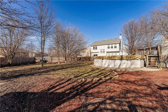 view of yard featuring a fenced in pool and fence