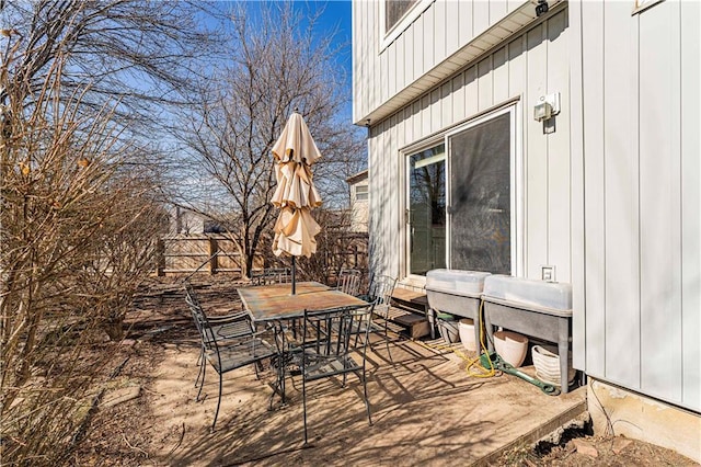 view of patio with outdoor dining space, area for grilling, and fence