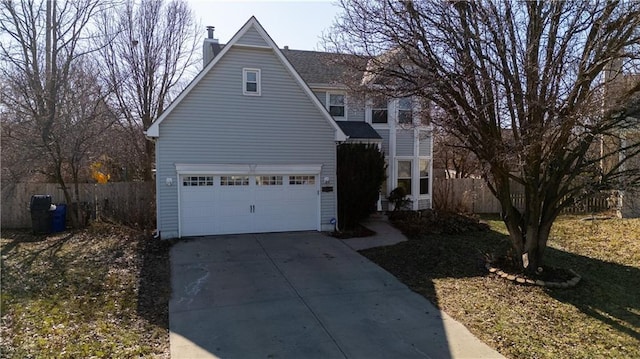 view of front of property featuring an attached garage, concrete driveway, a chimney, and fence