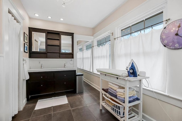 bathroom with tile patterned flooring and vanity