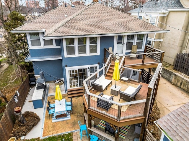 back of house featuring a wooden deck