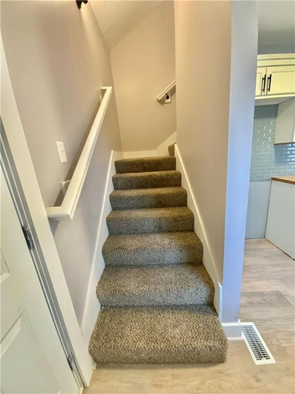 stairs with hardwood / wood-style floors