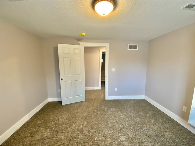 unfurnished bedroom featuring carpet floors and a textured ceiling