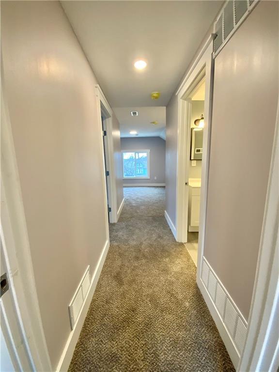 corridor featuring carpet floors