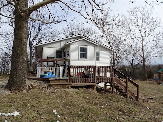 rear view of property featuring a deck