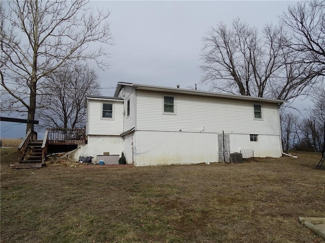 back of house with a yard, central AC, and a deck