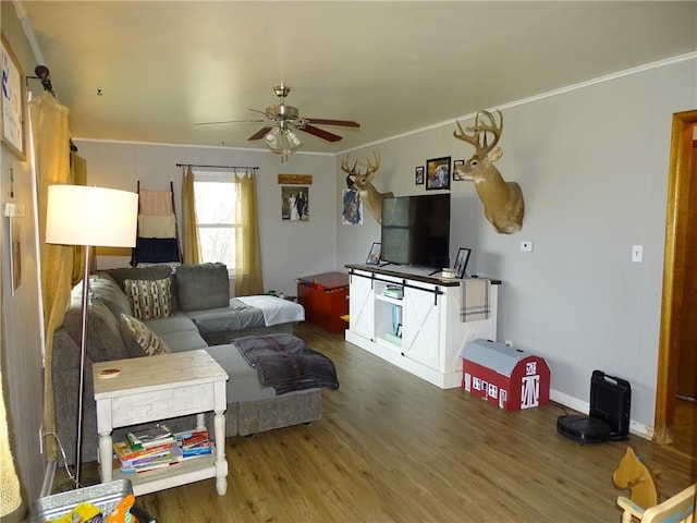 living room with crown molding, hardwood / wood-style floors, and ceiling fan