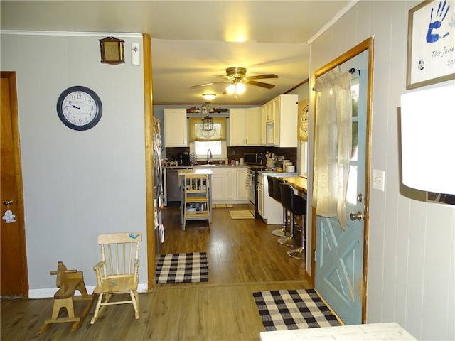 kitchen featuring sink, ceiling fan, white cabinetry, white electric range oven, and dark hardwood / wood-style flooring