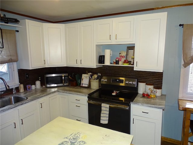 kitchen with white cabinetry, stainless steel appliances, sink, and tasteful backsplash