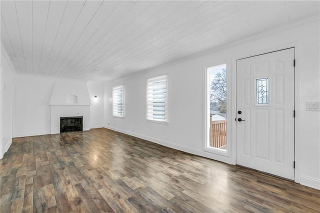 entrance foyer featuring wood ceiling, a fireplace, and dark hardwood / wood-style floors