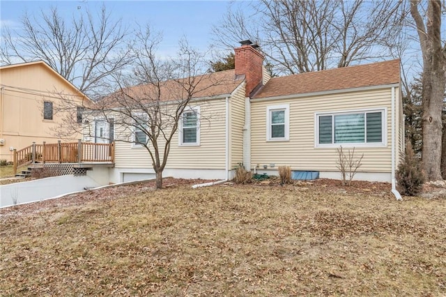 view of home's exterior featuring a wooden deck and a yard