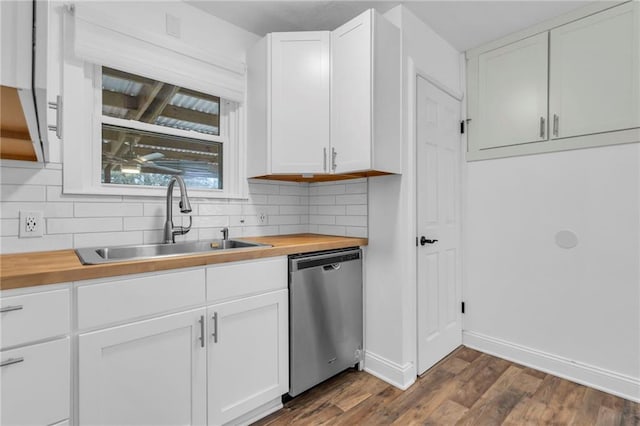 kitchen with white cabinetry, dishwasher, sink, and butcher block counters