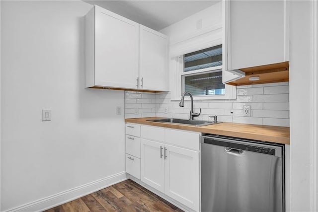 kitchen featuring wood counters, sink, stainless steel dishwasher, and white cabinets