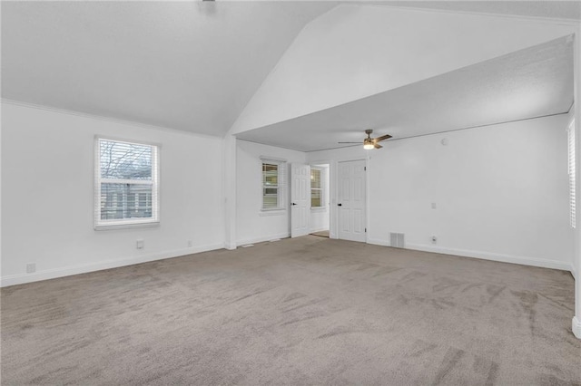 carpeted empty room with ceiling fan and high vaulted ceiling