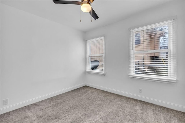 unfurnished room featuring ceiling fan, light colored carpet, and a healthy amount of sunlight