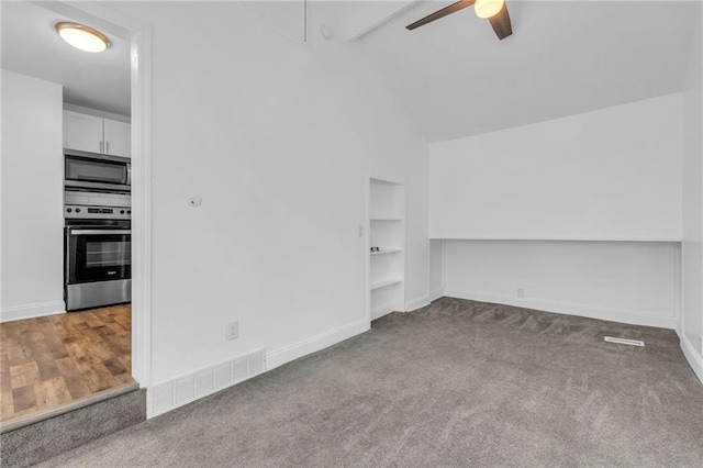 interior space with vaulted ceiling, built in features, and ceiling fan