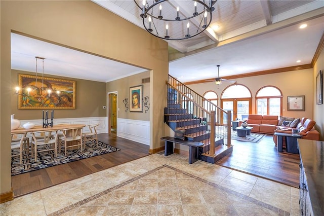 interior space featuring ornamental molding, stairway, and wainscoting