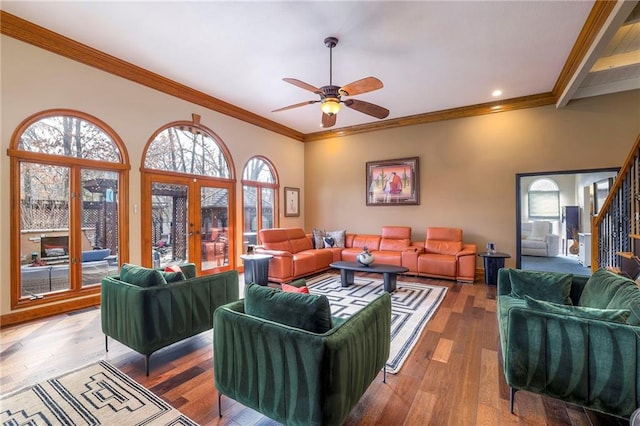 living room featuring a ceiling fan, stairs, french doors, ornamental molding, and wood-type flooring