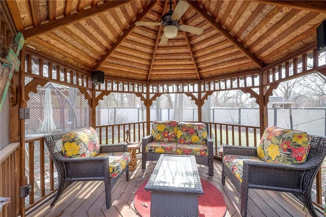 wooden terrace featuring ceiling fan, outdoor lounge area, and a gazebo