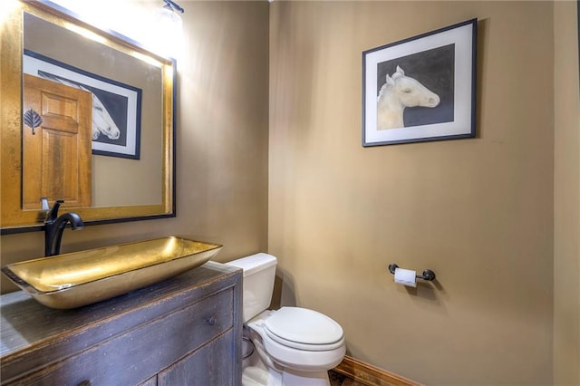 bathroom with toilet and vanity