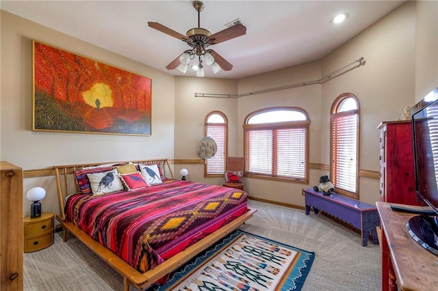 bedroom with ceiling fan, carpet flooring, and baseboards