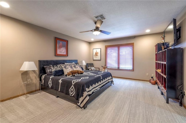 carpeted bedroom with a textured ceiling, recessed lighting, a ceiling fan, visible vents, and baseboards