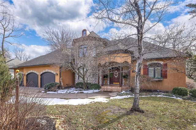 view of front of house featuring an attached garage, a shingled roof, a front yard, and stucco siding