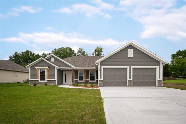 view of front of home with a garage and a front lawn