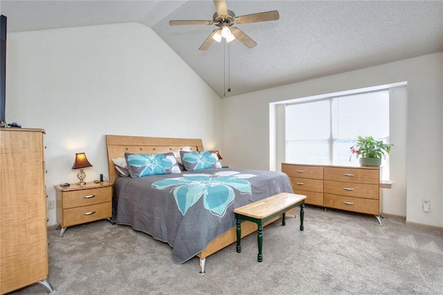 carpeted bedroom with ceiling fan and vaulted ceiling