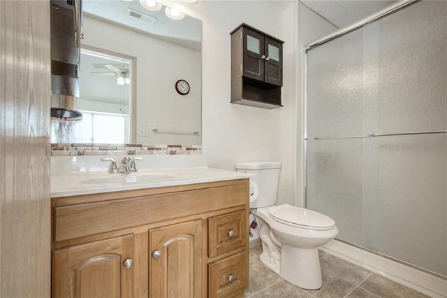 bathroom featuring an enclosed shower, tile patterned floors, toilet, ceiling fan, and vanity