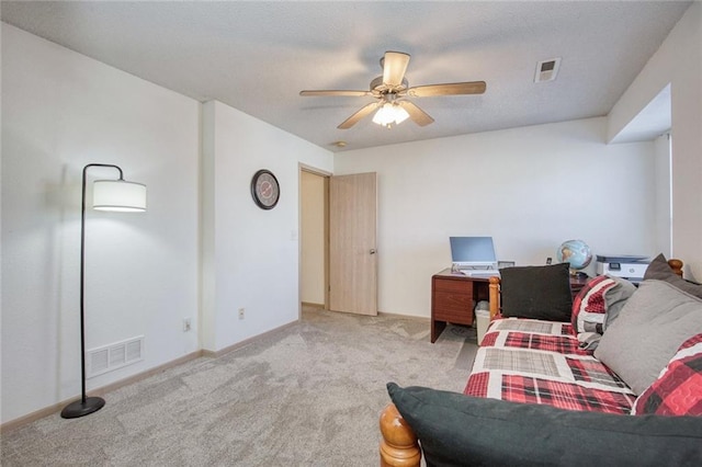 carpeted office space with ceiling fan