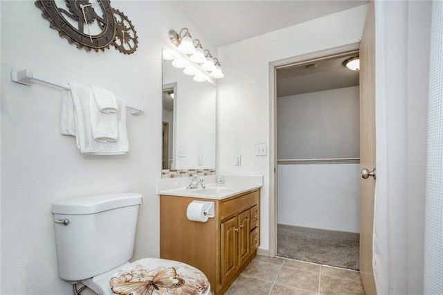 bathroom featuring tile patterned flooring, vanity, and toilet