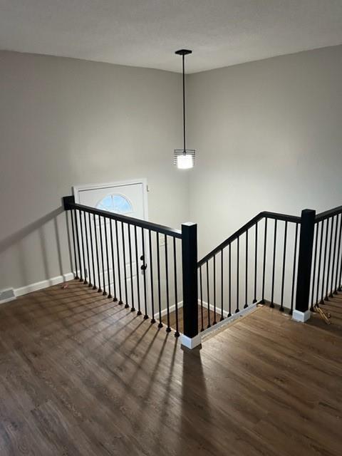 stairs with hardwood / wood-style floors