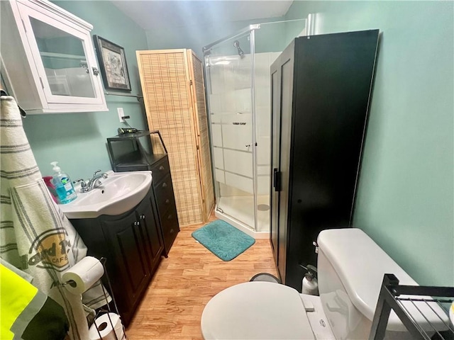 bathroom with vanity, hardwood / wood-style floors, toilet, and walk in shower