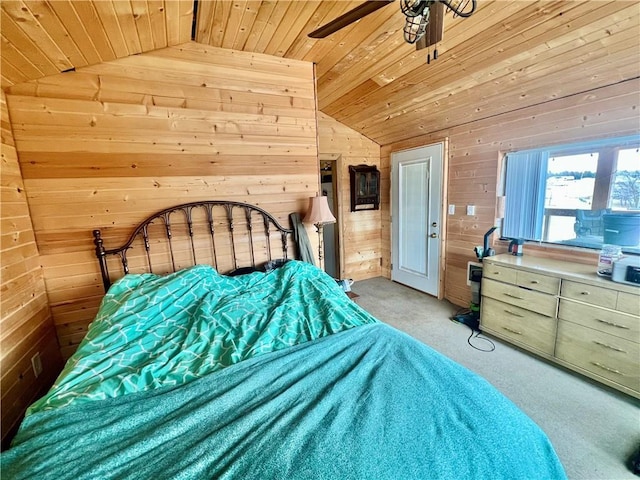 bedroom with lofted ceiling, wood ceiling, wooden walls, and light colored carpet