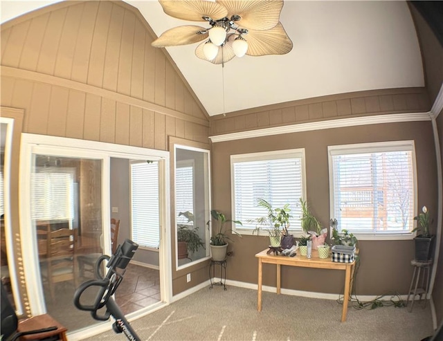 interior space with a wealth of natural light, ceiling fan, and vaulted ceiling