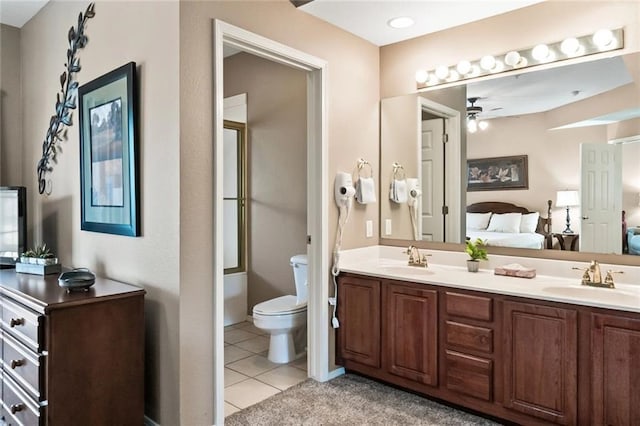 bathroom featuring tile patterned flooring, vanity, ceiling fan, and toilet