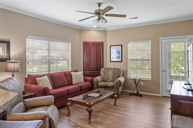 living room featuring crown molding, ceiling fan, and light hardwood / wood-style flooring