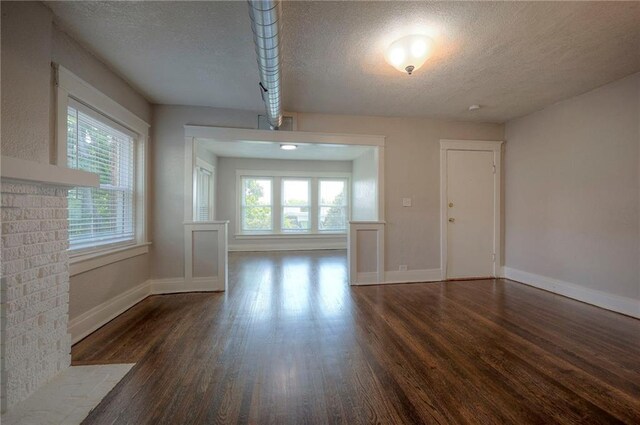 interior space featuring dark wood-type flooring and a textured ceiling